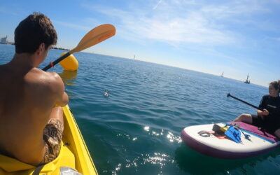 Two volunteers sampling waters on canoe
